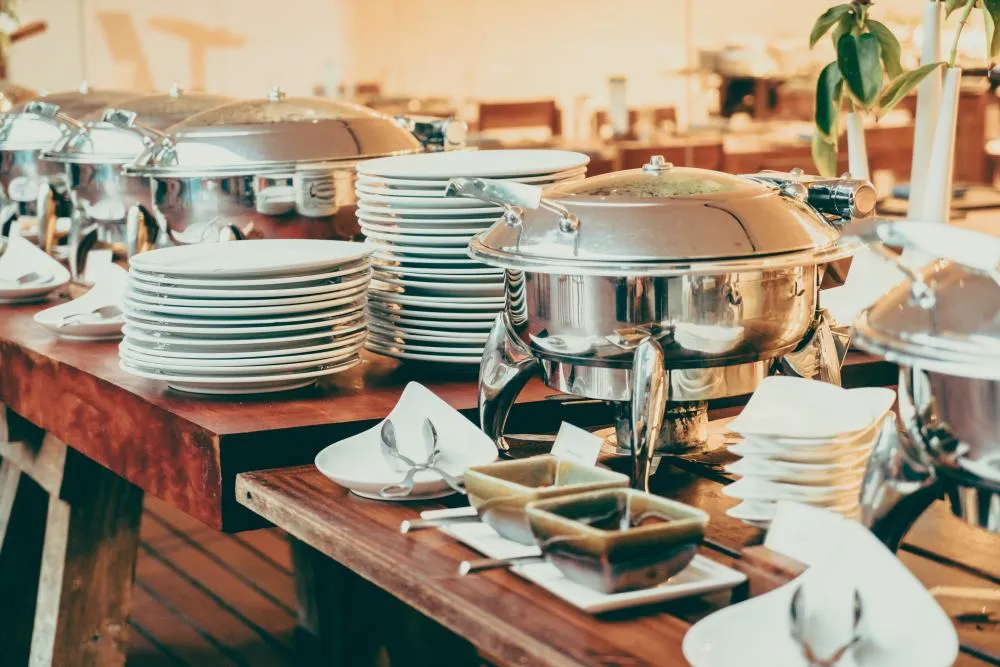 Stacked plates and chafing dishes ready for service